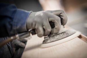 Sanding a piece of wood for recovery