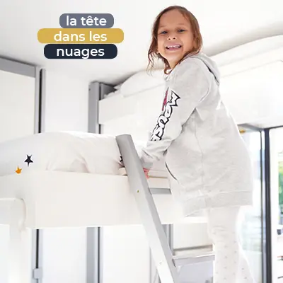 Petite fille heureuse de découvrir son lit escamotable aménagé pour les enfants